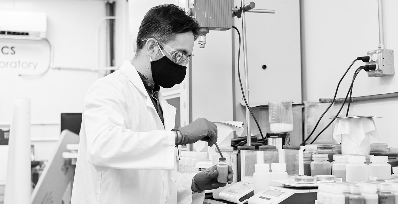 person in lab coat working in a lab