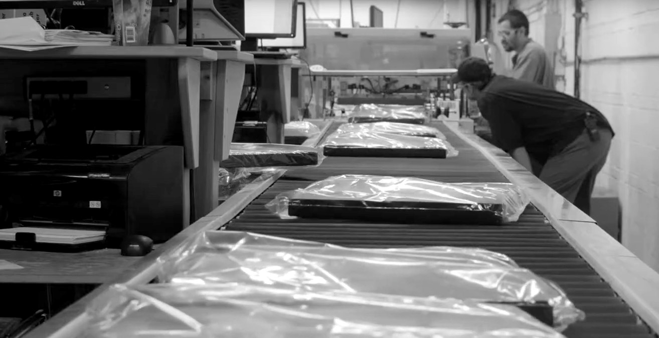 finished canvases on a conveyor in a factory